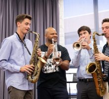 Four men play brass instruments together. Click to learn more about honorary degrees.